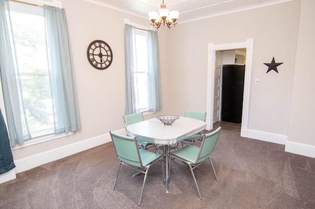 217 Center St, Mankato, MN 56001 - carpeted dining area featuring crown molding, baseboards, and an inviting chandelier
