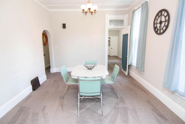 217 Center St, Mankato, MN 56001 - dining area with arched walkways, a notable chandelier, baseboards, and carpet floors