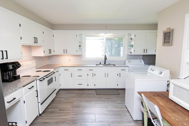 217 Center St, Mankato, MN 56001 - kitchen featuring white cabinets, washer and dryer, white appliances, and a sink