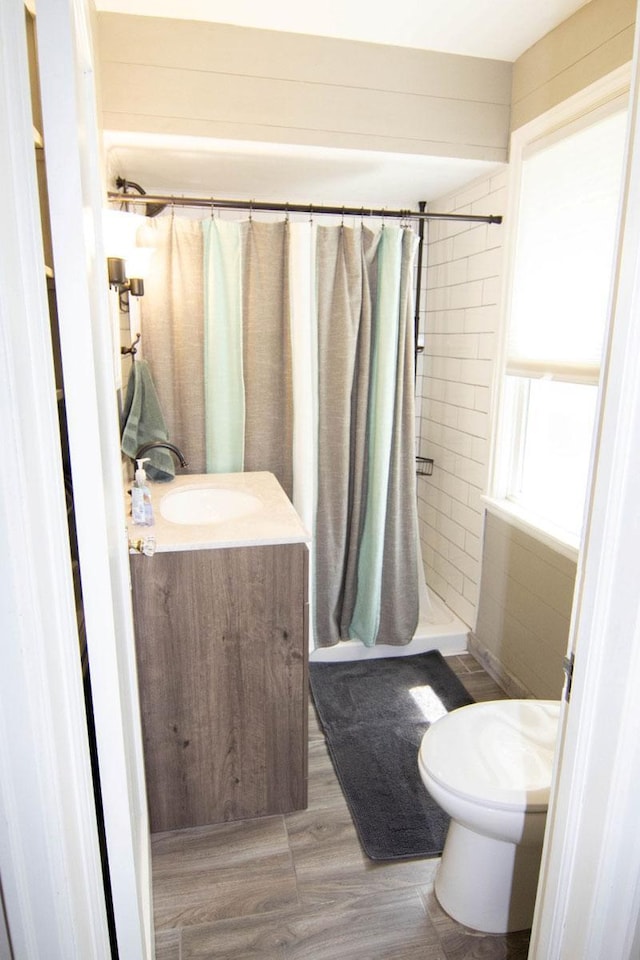 217 Center St, Mankato, MN 56001 - full bath with tiled shower, vanity, toilet, and wood finished floors