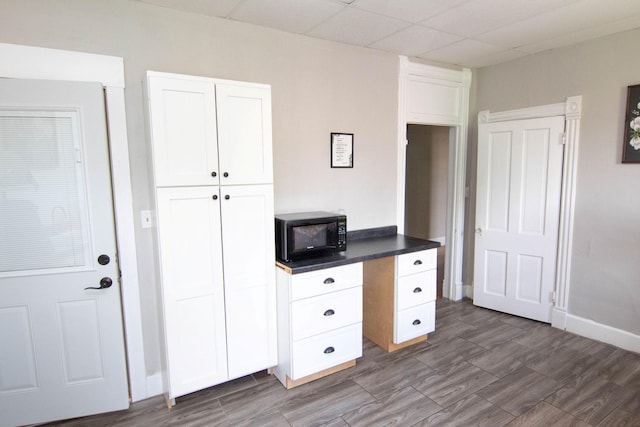 217 Center St, Mankato, MN 56001 - unfurnished office featuring dark wood-type flooring, a paneled ceiling, and baseboards