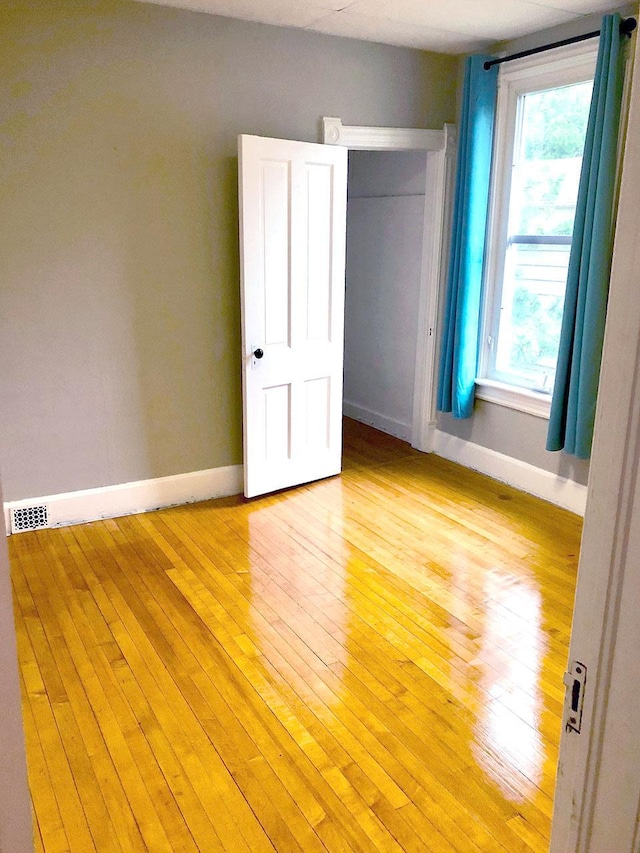217 Center St, Mankato, MN 56001 - unfurnished bedroom with a closet, light wood-style flooring, and baseboards