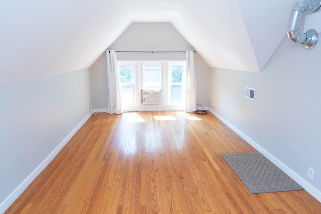 217 Center St, Mankato, MN 56001 - additional living space with visible vents, baseboards, light wood finished floors, and vaulted ceiling