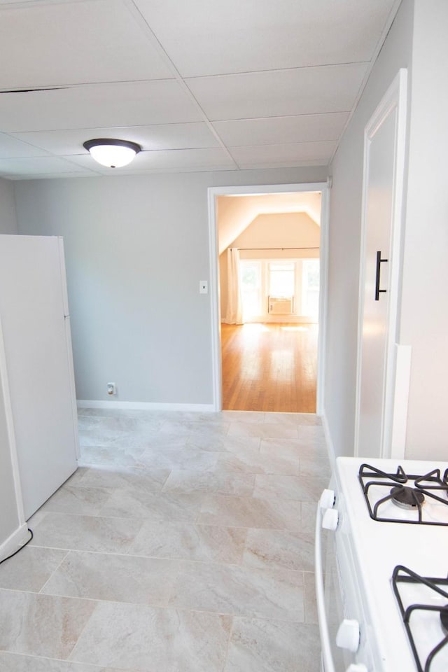 217 Center St, Mankato, MN 56001 - interior space with a drop ceiling, light tile patterned flooring, baseboards, and white appliances