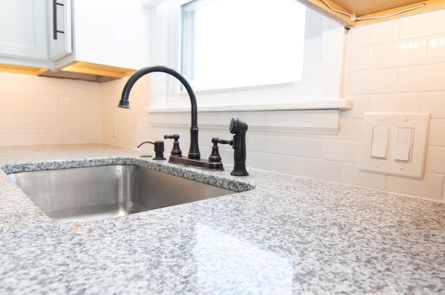 217 Center St, Mankato, MN 56001 - room details with a sink, tasteful backsplash, and light stone countertops