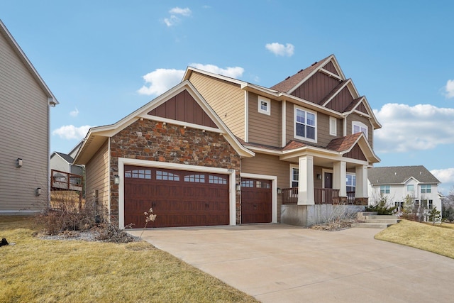 craftsman-style house featuring board and batten siding, concrete driveway, stone siding, and covered porch