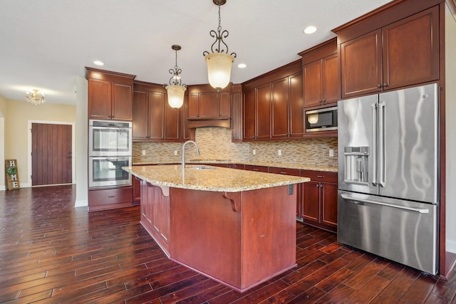 kitchen featuring appliances with stainless steel finishes, decorative backsplash, a sink, and dark wood-style floors