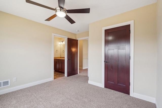 unfurnished bedroom featuring connected bathroom, a ceiling fan, visible vents, carpet flooring, and baseboards