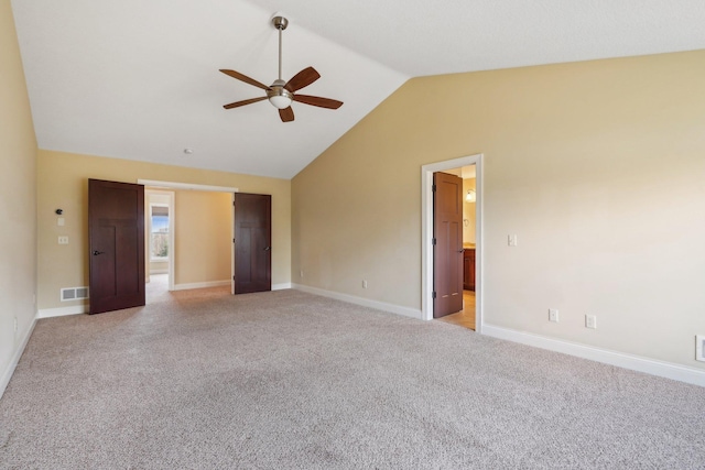unfurnished bedroom featuring ceiling fan, light colored carpet, visible vents, lofted ceiling, and baseboards