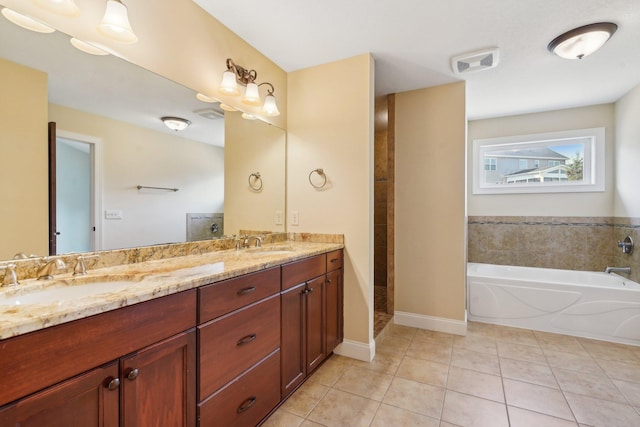 full bathroom featuring a sink, visible vents, a bath, and tile patterned flooring