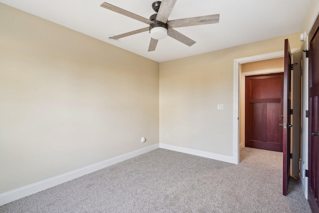 unfurnished room featuring baseboards, a ceiling fan, and carpet flooring