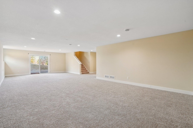 interior space featuring visible vents, stairway, recessed lighting, light carpet, and baseboards