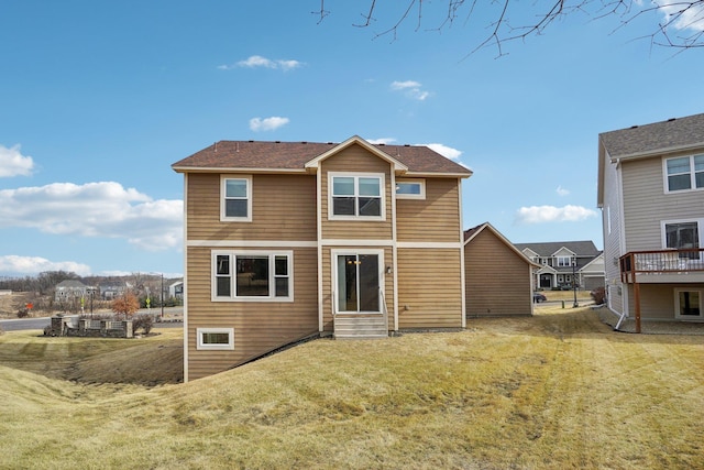 back of property featuring a lawn