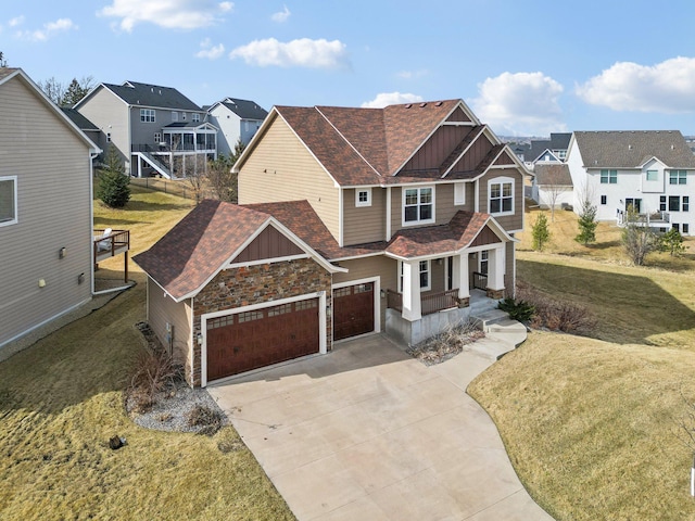 craftsman-style home featuring board and batten siding, an attached garage, a residential view, and driveway