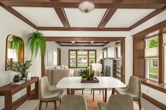 509 Nicollet Ave, North Mankato, MN 56003 - carpeted dining room featuring coffered ceiling, healthy amount of natural light, beam ceiling, a fireplace, and baseboards