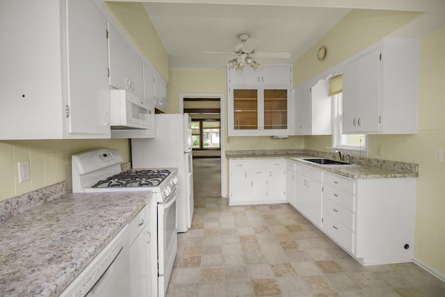 509 Nicollet Ave, North Mankato, MN 56003 - kitchen with white appliances, ceiling fan, light countertops, white cabinets, and a sink