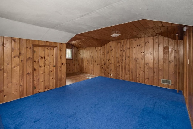 509 Nicollet Ave, North Mankato, MN 56003 - additional living space featuring wooden walls, lofted ceiling, and carpet flooring