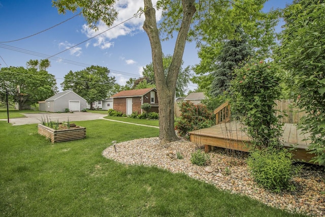 509 Nicollet Ave, North Mankato, MN 56003 - view of green lawn featuring a wooden deck, a detached garage, and driveway