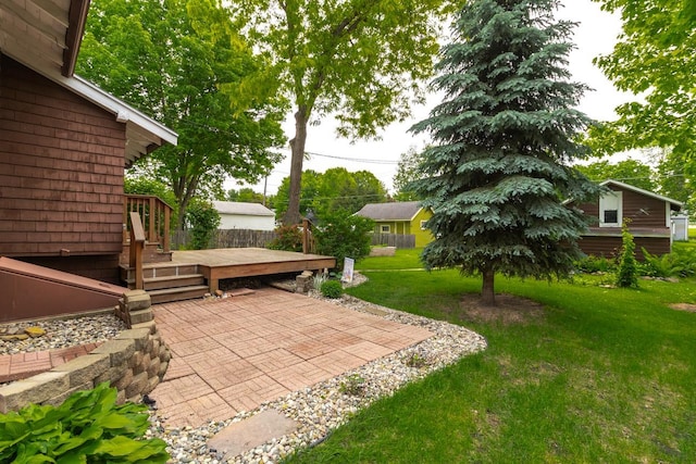 509 Nicollet Ave, North Mankato, MN 56003 - view of green lawn featuring a wooden deck and a patio area