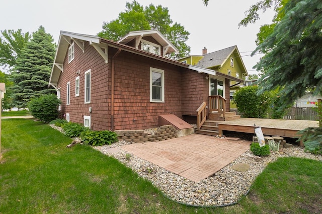 509 Nicollet Ave, North Mankato, MN 56003 - back of property featuring a wooden deck, a yard, and a patio