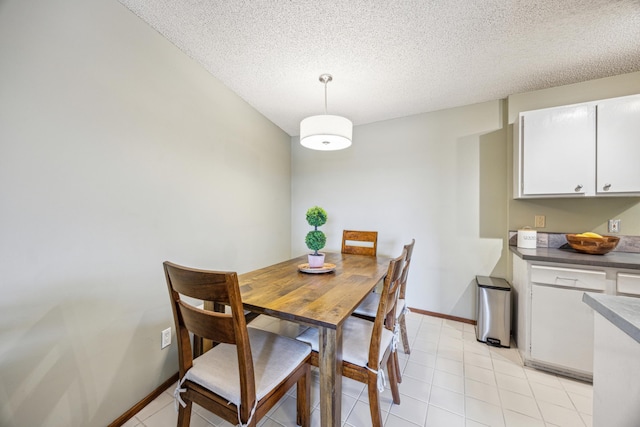 210 Grant St Unit 710, Minneapolis, MN 55403 - dining room with baseboards, a textured ceiling, and light tile patterned floors