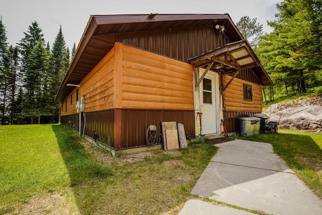 5242 Cusson Loop Rd, Leiding Twp, MN 55771 - view of side of property with a lawn, faux log siding, and board and batten siding