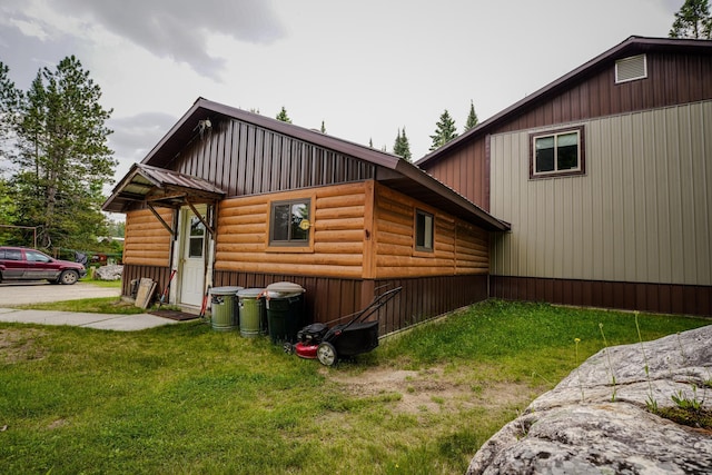 5242 Cusson Loop Rd, Leiding Twp, MN 55771 - view of side of property featuring faux log siding and a lawn