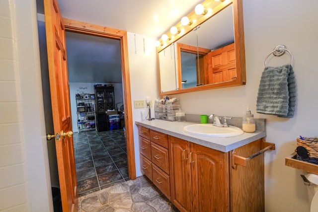 5242 Cusson Loop Rd, Leiding Twp, MN 55771 - bathroom featuring vanity and stone finish flooring