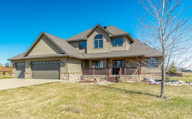 view of front facade with a front yard, a shingled roof, a porch, an attached garage, and driveway