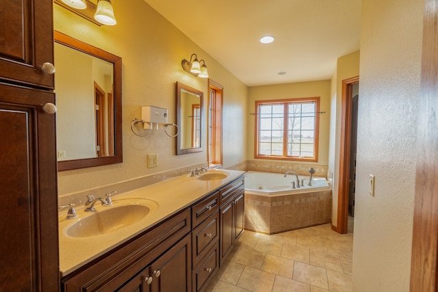bathroom with a sink, tile patterned floors, a bath, and double vanity