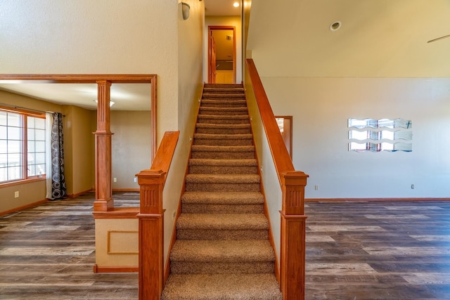 stairway with baseboards and wood finished floors