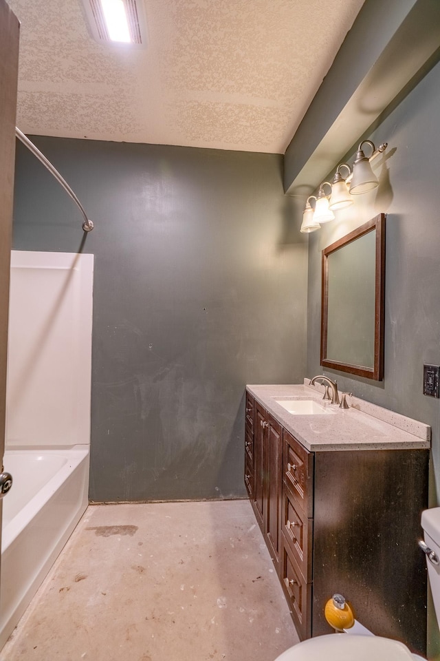 bathroom featuring washtub / shower combination, toilet, a textured ceiling, concrete flooring, and vanity
