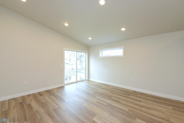spare room with vaulted ceiling, baseboards, light wood-style floors, and recessed lighting