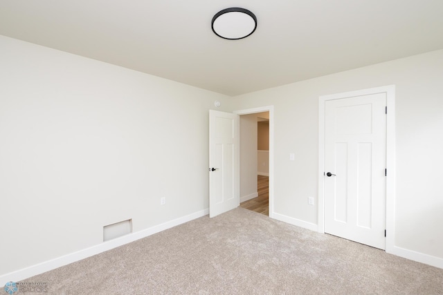 unfurnished bedroom with carpet flooring and baseboards