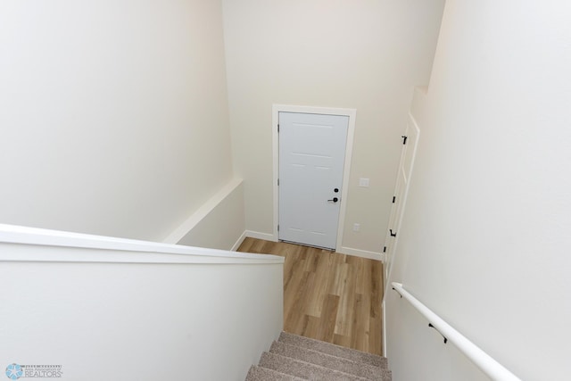 stairs featuring baseboards and wood finished floors