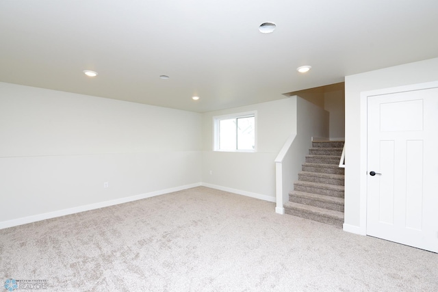 below grade area featuring recessed lighting, carpet floors, baseboards, and stairway
