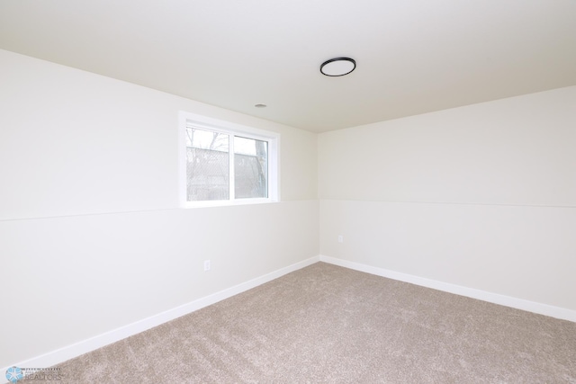 carpeted spare room with baseboards