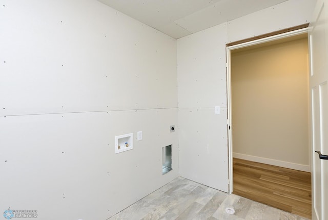 clothes washing area with electric dryer hookup, light wood-style flooring, laundry area, and washer hookup