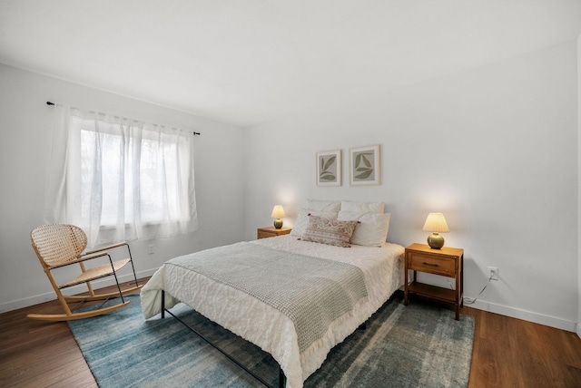 bedroom featuring wood finished floors and baseboards