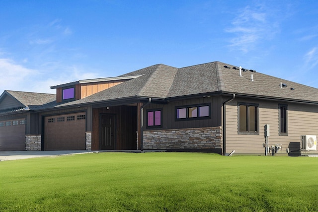 7284 205th St W, Faribault, MN 55021 - prairie-style house featuring a garage, stone siding, board and batten siding, a shingled roof, and a front yard