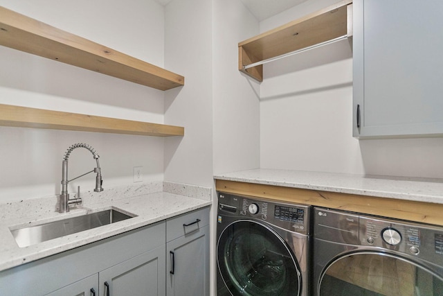 7284 205th St W, Faribault, MN 55021 - washroom featuring separate washer and dryer, cabinet space, and a sink