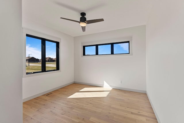 7284 205th St W, Faribault, MN 55021 - unfurnished room featuring light wood-style floors, a healthy amount of sunlight, baseboards, and ceiling fan