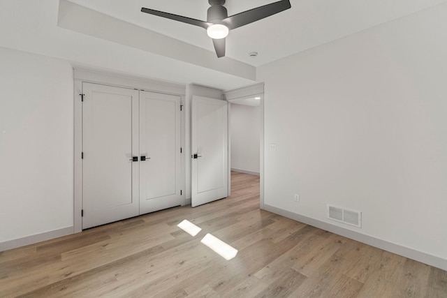7284 205th St W, Faribault, MN 55021 - unfurnished bedroom featuring light wood-type flooring, visible vents, baseboards, and ceiling fan