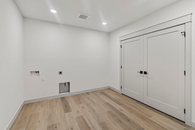 7284 205th St W, Faribault, MN 55021 - washroom with electric dryer hookup, laundry area, light wood finished floors, visible vents, and washer hookup