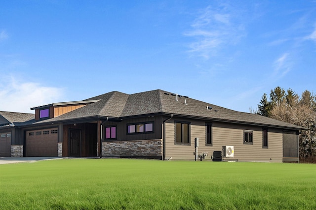 7284 205th St W, Faribault, MN 55021 - view of front of property with a shingled roof, an attached garage, driveway, stone siding, and a front yard