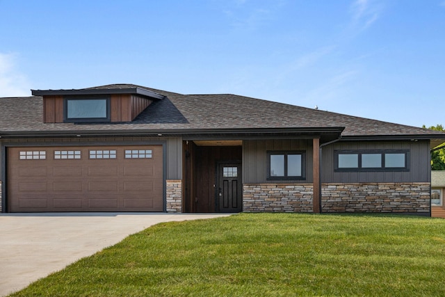 7284 205th St W, Faribault, MN 55021 - view of front of house with driveway, stone siding, a front yard, a garage, and board and batten siding