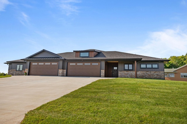 7284 205th St W, Faribault, MN 55021 - prairie-style home with stone siding, an attached garage, concrete driveway, and a front yard