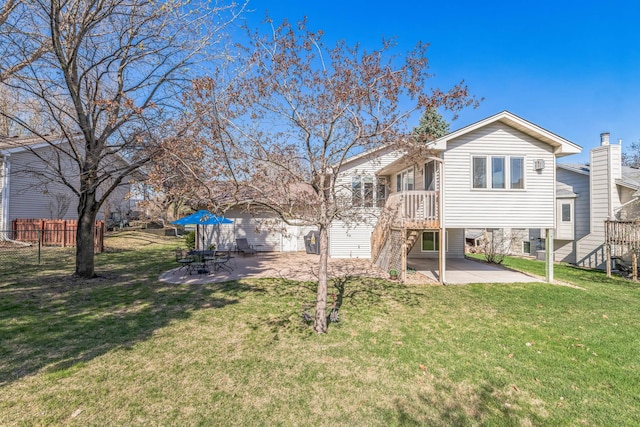 back of house with a carport, a yard, and a patio area