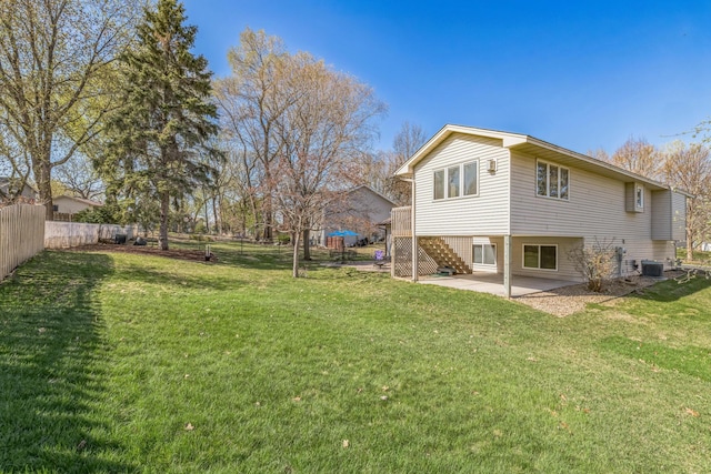 back of house with fence, stairs, a patio, and a yard