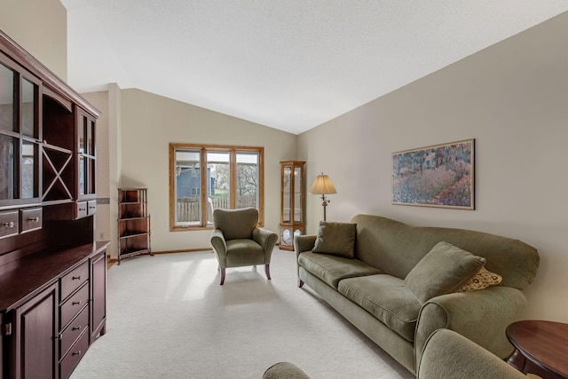 living room featuring baseboards, light carpet, and vaulted ceiling